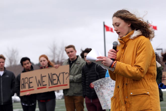 Junior Molly Schwall, a Parkland resident from 2008-2012, talks about her experience worrying about her friend who was trapped in a closet after her phone died during the Parkland shooting during the walkout at Hingham High on Wednesday, March 21, 2018. [Wicked Local Staff Photo/ Robin Chan]