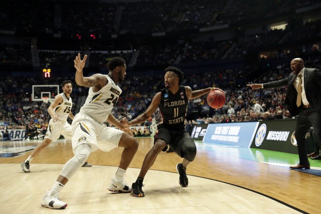 Florida State guard Braian Angola (11) works the ball against Missouri forward Kevin Puryear (24) at the NCAA tournament on Friday. Florida State plays Gonzaga on Thursday in the third round of the tournament in the West Region.  [The Associated Press]