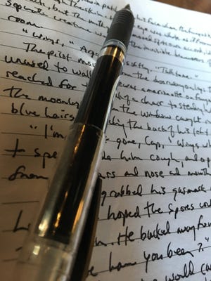 When it comes to rituals, all writers have them. One of mine is handwriting my first drafts. (I prefer unlined paper, but this journal was a gift.) [TONY SIMMONS/THE NEWS HERALD]