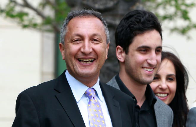 FILE - In this April 21, 2011 file photo shows MGA chief executive Isaac Larian, left, leaves federal court in Santa Ana, Calif., after a victory over Mattel Inc. The CEO of the maker of the pouty Bratz dolls is launching a campaign to salvage some of Toys R Us' U.S. business being liquidated in bankruptcy. (AP Photo/Christine Cotter, File)
