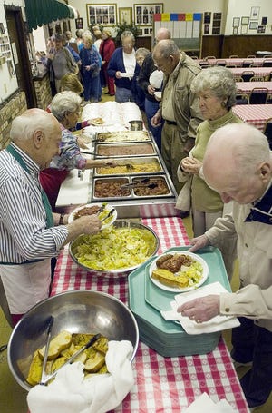 A crowd lines up to be served pasta at the Sons and Daughtes of Italy Friday pasta night in 2007. [FILE PHOTO/DAILY NEWS]