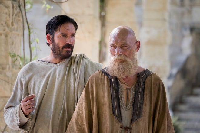 Jim Caviezel, left, plays Luke and James Faulkner is his colleague Paul in the biblical drama "Paul, Apostle of Christ." [Columbia Pictures]