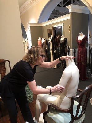 Dressing Downton costume curator Nancy Lawson assists in dismantling the exhibit's 36 costumes. [CONTRIBUTED]