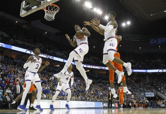 Kansas' Silvio De Sousa pulls down a rebound during the first half of a regional semifinal game against Clemson in the NCAA Tournament on Friday in Omaha, Neb. [The Associated Press / Charlie Neibergall]