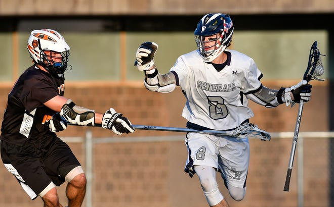 Alex Winch of Hamilton-Wenham controls the ball as he is pressured by Billy Koshivas of Ipswich during H_W's Division 3 tournament game loss, 11-7, at Peabody High School on June 9, 2017. [Wicked Local Staff Photo / David Sokol]