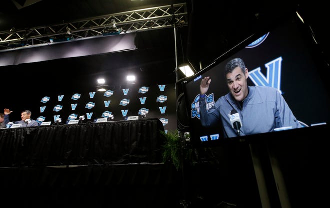 Villanova coach Jay Wright is seen on a monitor as he speaks during a news conference at the NCAA men's college basketball tournament, Saturday, March 24, 2018, in Boston. Villanova faces Texas Tech in a regional final on Sunday. (AP Photo/Elise Amendola)