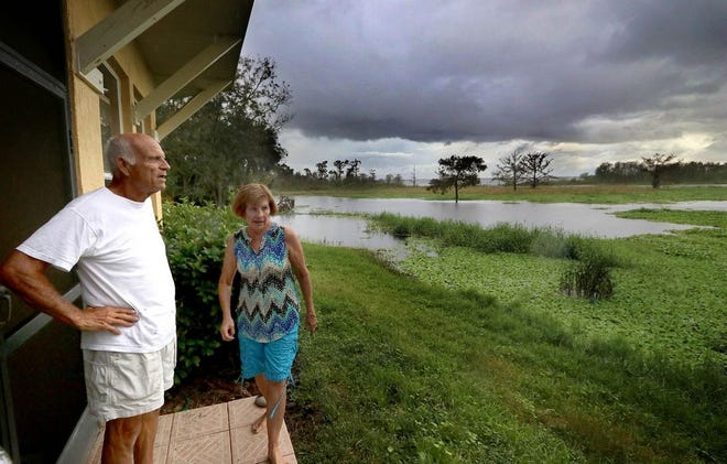 Roy and Sandy Walters discuss the flooding in their backyard from the St. Johns River in the Stone Island community about a month after Hurricane Irma moved through. [NEWS-JOURNAL / Jim Tiller]
