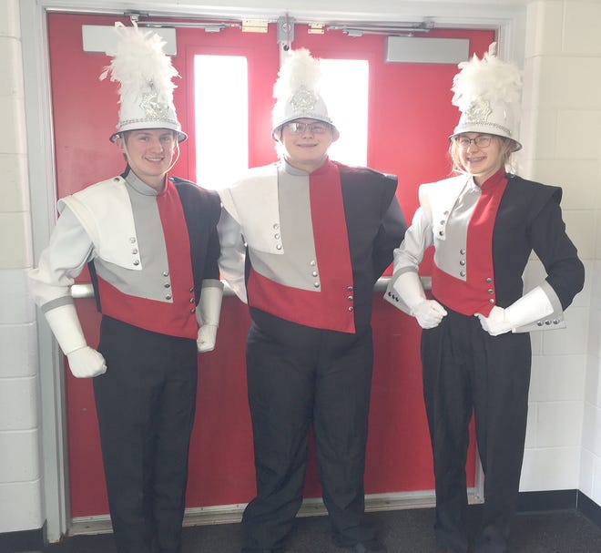 Camden-Frontier High School marching band members Dylan Keller, Jared Collins and Jade Cuff show off their new uniforms.