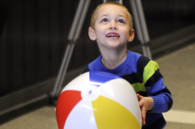 Giovanni Kleppinger, 4, plays with a beach ball at his Make-A-Wish reveal celebration at Pocono Mountain West High School on Friday, March 23, 2018. Giovanni was born with a brain malformation that was not recognized by doctors until he was about two years old. He is an animal lover and wanted to swim with dolphins, and he'll get the chance to do just that when he and his mother travel to Key West in May. [Keith R. Stevenson/Pocono Record]