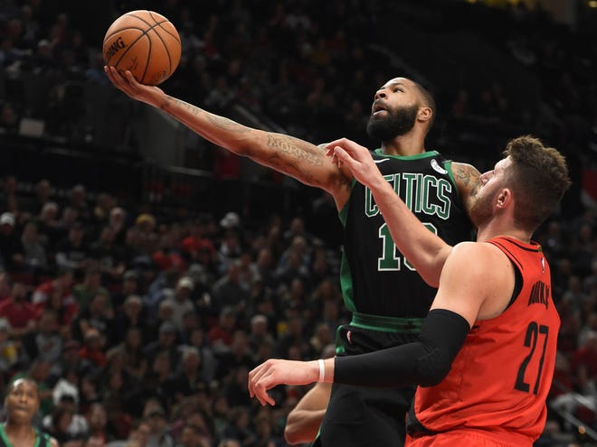 Celtics forward Marcus Morris drives to the basket in front of Portland Trail Blazers center Jusuf Nurkic during the second half of Friday's game in Portland, Ore.