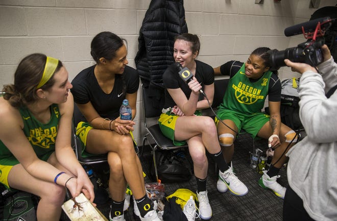 Oregon Ducks including Sierra Campisano (left), Satou Sabally, Aina Ayuso and Oti Gildon talk with media in their locker room after arriving in Spokane for the Sweet 16. (Chris Pietsch/The Register-Guard)