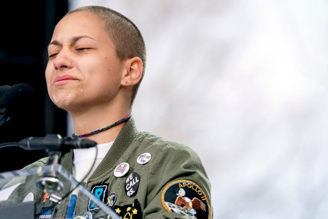 Emma Gonzalez, a survivor of the mass shooting at Marjory Stoneman Douglas High School in Parkland, closes her eyes and cries as she stands silently at the podium and times the amount of time it took the Parkland shooter to go on his killing spree during the March for Our Lives rally in support of gun control Saturday in Washington. [Andrew Harnik/The Associated Press]
