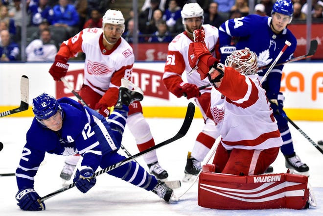 Detroit Red Wings goaltender Jimmy Howard (35) makes a save on Toronto Maple Leafs center Patrick Marleau (12) during the second period of an NHL hockey game Saturday, March 24, 2018, in Toronto. (Frank Gunn/The Canadian Press via AP)