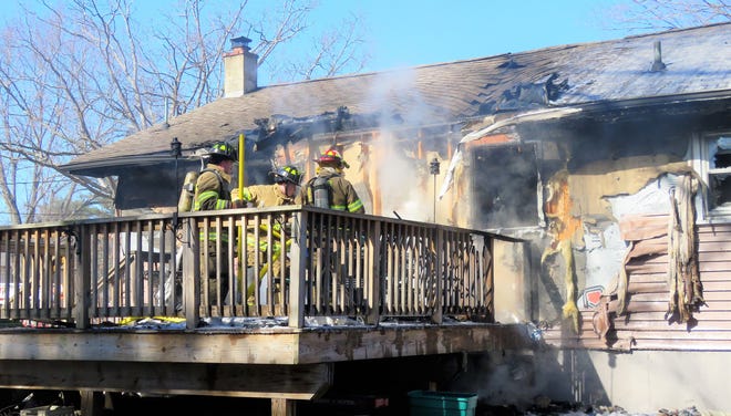 Members of the Cuddebackville Fire Department extinguish a fire Friday afternoon at a house on Maple Lane in the hamlet. [SHARON E. SIEGEL/FOR THE TIMES HERALD-RECORD]