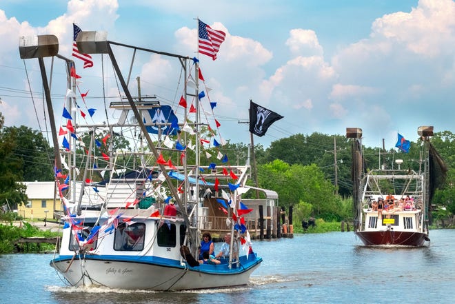 Decorated boats glide down Bayou Little Caillou in Chauvin on July 9 for the community's annual blessing of the shrimp fleet. Usually held in April, last year's procession was postponed because of stormy weather. [File -- houmatoday/dailycomet]