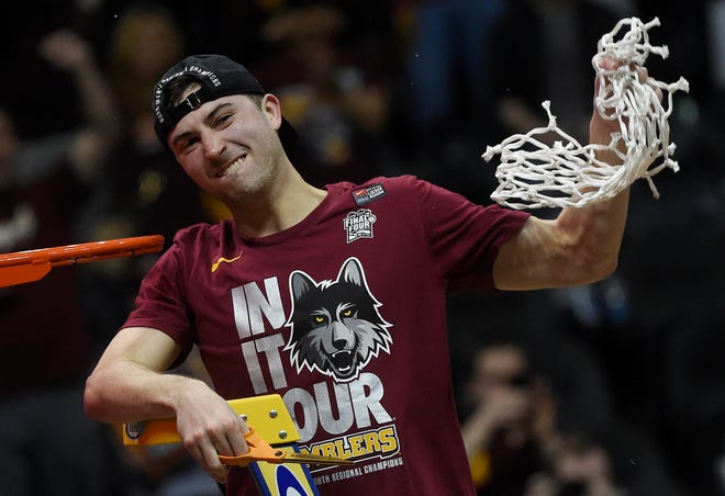 Loyola-Chicago guard Ben Richardson holds the net after a regional final game against Kansas State.