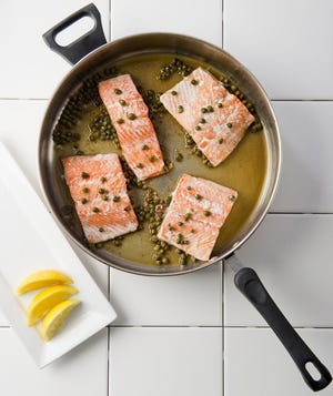 Salmon filets cooked with anchovy butter and capers. [FILE PHOTO/ERIE TIMES-NEWS]