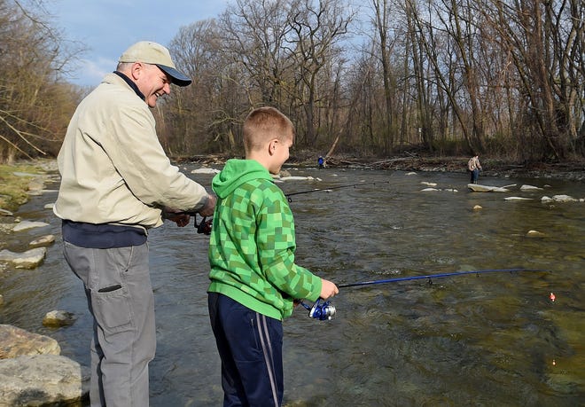 Don Boetger and his grandson Donovan Hunter, 9, both of Erie, fish together on the bank of Twenty Mile Creek in North East Township on the opening day of trout season April 15, 2017. [DAVE MUNCH/ERIE TIMES-NEWS]