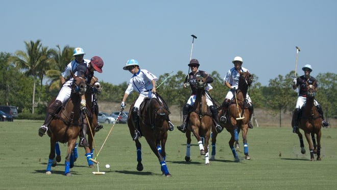 Poroto Cambiaso, 12, battles for the ball with Henry Porter during the Audi-Valiente match in Friday’s Sterling Cup at International Polo Club Palm Beach.