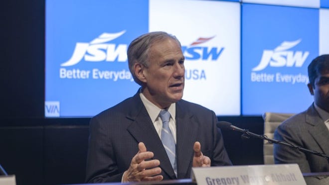 Texas Gov. Greg Abbott and Parth Jindal of JSW USA, which plans to expand its steel plant in Baytown, speak at a news conference on Monday, March 26, 2018, at the Mumbai, India, headquarters of the company’s parent, JSW Group.(Cody Kloster/Office of the Governor)