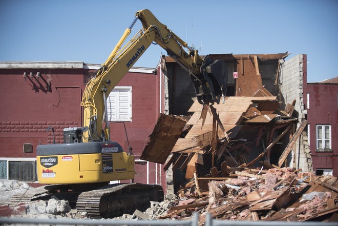 Demolition of the Robbins Auto block in Dover began on Monday with the rear section coming down first. [John Huff/Fosters.com]