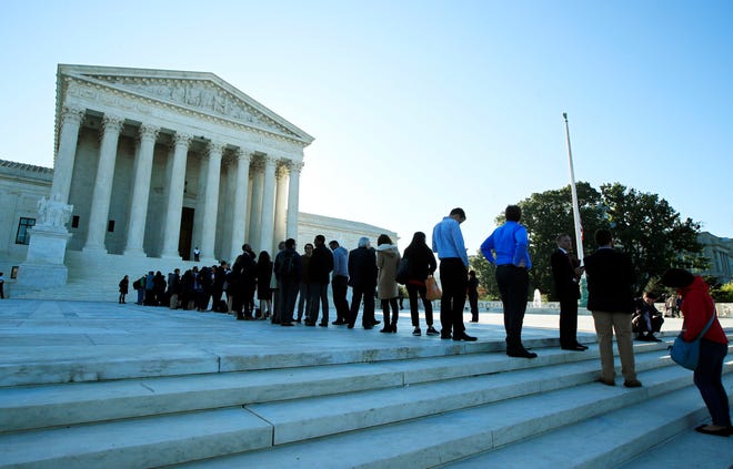 In this Oct. 3, 2017 photo, people line up outside the U.S. Supreme Court in Washington to hear arguments in a case about political maps in Wisconsin that could affect elections across the country. The Supreme Court has already heard a major case about political line-drawing that has the potential to reshape American politics. Now, before even deciding that one, the court is taking up another similar case. Decisions in the Maryland case and the earlier one from Wisconsin are expected by late June. (AP file Photo/Manuel Balce Ceneta)