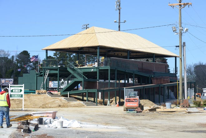 Workers had the roof of the two-story hospitality structure nearly complete early Monday and should be finishing up the two bars on each floor and seating by the end of the week. [Janet S. Carter / The Free Press]