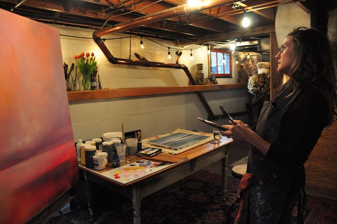 Meredith Mallwitz paints in her Canandaigua studio. [PHOTO PROVIDED/MAIN STREET ARTS]