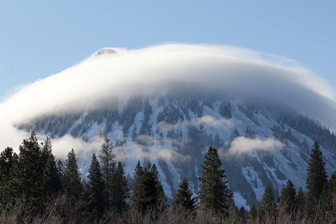 Black Butte, between the cities of Mount Shasta and Weed, wore a cloud scarf Monday morning, March 26, 2018.