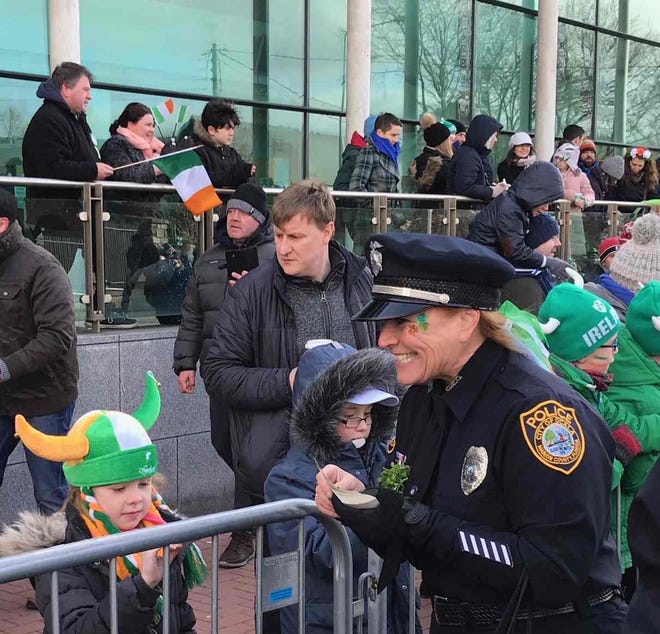 Ocala Police Department Office Patricia Mraz, at right, speaks to children along the route of the St. Patrick's Day parade in Newbridge, Ireland. A contingent of 42 Ocalans recently visited the city of Ocala's twinning city of Newbridge. They participated in the parade, attended solemn remembrance ceremonies and visited several locations of note in the area. [Submitted photo]