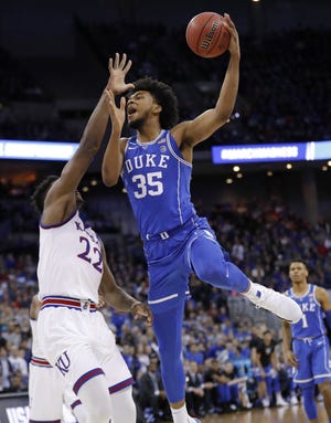 Duke's Marvin Bagley III shoots over Kansas' Silvio De Sousa during Sunday's regional championship game. Bagley, a freshman, averaged 22.5 points and 11.5 rebounds. It's uncertain if he will return to Duke next season or turn pro. [Charlie Neibergall/The Associated Press]
