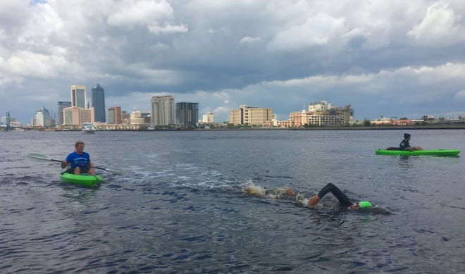 Luther Davis swims Sunday afternoon through downtown Jacksonville. Davis, a Lake Mary High School teacher, spent his spring break swimming the St. Johns River from near his home in Sanford to the Atlantic Ocean. (MARK WOODS/FLORIDA TIMES-UNION)