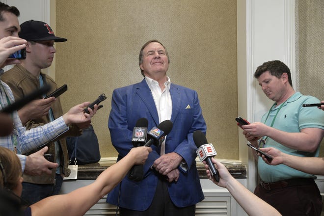 Patriots head football coach Bill Belichick (center) answers questions from reporters at the coaches breakfast during the NFL owners meetings on Tuesday in Orlando, Fla. [Phelan M. Ebenhack/AP Images for NFL]