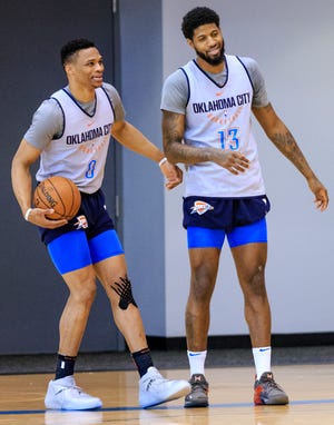 Russell Westbrook, left, and Paul George share a light moment during a Thunder practice in March. [PHOTO BY CHRIS LANDSBERGER, THE OKLAHOMAN]
