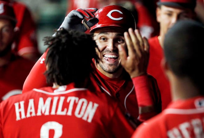 Cincinnati Reds' Adam Duvall (23) is congratulated by teammate Billy Hamilton (6) after hitting a solo home run during the sixth inning of a spring training baseball game against the Texas Rangers Monday, March 26, 2018, in Arlington, Texas. (AP Photo/Brandon Wade)
