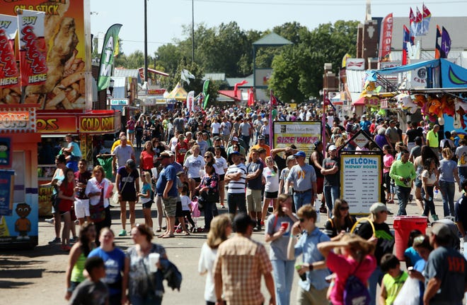 Fairgoers make their way along Cottonwood Avenue during the Kansas State Fair on Sunday, Sept. 20, 2015. [file photo]