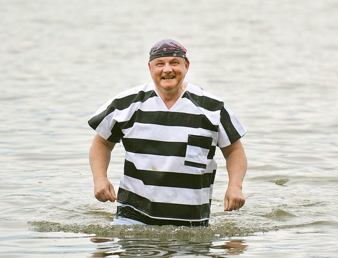 Steuben County Sheriff James Allard comes back to shore after taking a swim at the annual Tyrtle Beach Fundraiser at Lake Salubria in Bath in 2017. [ERIC WENSEL/THE LEADER]