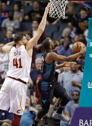 Charlotte Hornets' Kemba Walker (15) drives past Cleveland Cavaliers' Ante Zizic (41) during the second half of an NBA basketball game in Charlotte, N.C., Wednesday, March 28, 2018. Walker passed former Hornet Dell Curry as the all-time scoring leader for the team with the basket. (AP Photo/Chuck Burton)