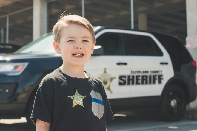 Landon Dycus met members of the Cleveland County Sheriff's Office for his police-themed fourth birthday. [Photos courtesy of At First Glance Photography]