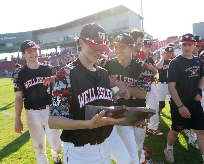 John Woernle (holding the trophy) and the Wellesley baseball team won the Division 1 South championship last spring after squeaking into the tournament. This year, with an experienced pitching staff, the Raiders are looking to make another run.