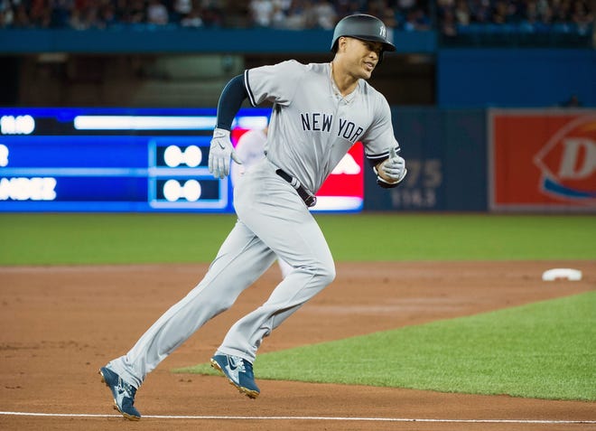 New York Yankees' Giancarlo Stanton rounds the bases after hitting a two-run home run during first-inning baseball game action against the Toronto Blue Jays in Toronto on Thursday. [THE CANADIAN PRESS/Nathan Denette/The Canadian Press via AP]