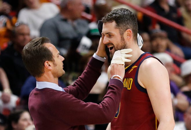 Cleveland Cavaliers center Kevin Love (0) is attended to after a first quarter injury during play against the Miami Heat in an NBA basketball game, Tuesday, March 27, 2018, in Miami. The Heat won the game 98-79. (AP Photo/Joe Skipper)