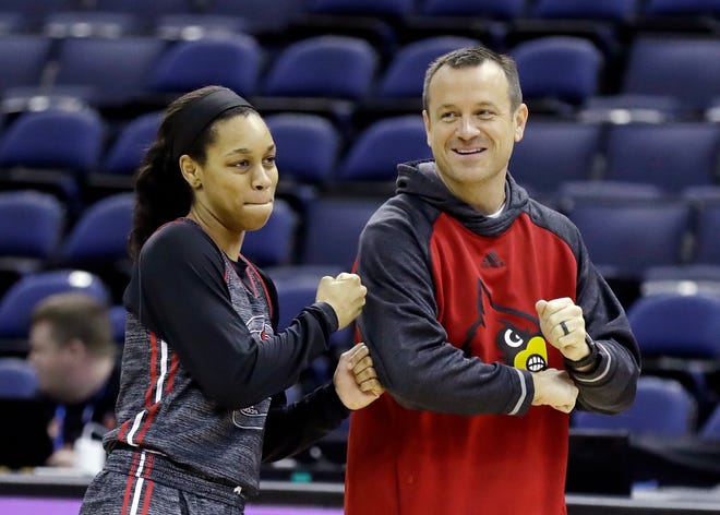 Louisville's Asia Durr punches head coach Jeff Walz during a practice session for the women's NCAA Final Four college basketball tournament, Thursday, March 29, 2018, in Columbus, Ohio. Louisville plays Mississippi State on Friday. (AP Photo/Ron Schwane)