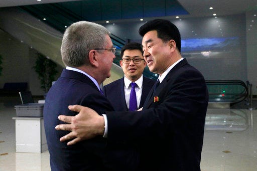 International Olympic Committee (IOC) President Thomas Bach, left, is greeted by North Korean Sports Minister Kim Il Guk on his arrival at the Pyongyang Airport in North Korea, Thursday, March 29, 2018. IOC President Bach arrived in North Korea on Thursday after playing a key role in allowing it to participate in last month's Pyeongchang Olympic Games in South Korea. (AP Photo/Jon Chol Jin)