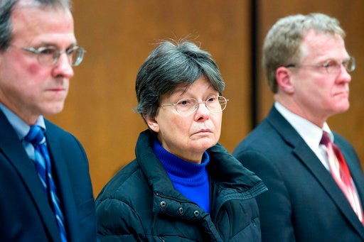 This photo taken Feb. 13, 2018, showsLinda Kosuda-Bigazzi, 70, center, appears at Bristol Superior court for a hearing on a murder charge, in Bristol, Conn. Linda Kosuda-Bigazzi is charged with murder in the death of her husband, Dr. Pierluigi Bigazzi, a professor of laboratory science and pathology at UConn Health. The University of Connecticut announced Thursday, March 29, 2018, that it has recovered more than $50,000 it paid to a slain researcher while it believed he was working from home. Police checking on the welfare of Dr. Bigazzi, found his body on Feb. 5 wrapped in plastic inside the house he shared with his wife. (Patrick Raycraft/Hartford Courant via AP, Pool)