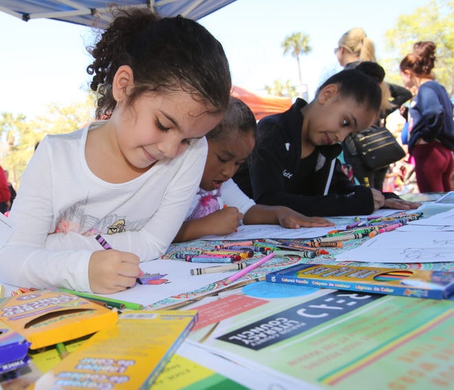 Isabella Pena, Kaitlin Mitsunaga and Scarlett Kelly, left to right, color at last year's Superintendent's Literacy Festival. This years festival runs April 7. [Bruce Ackerman/File photo]
