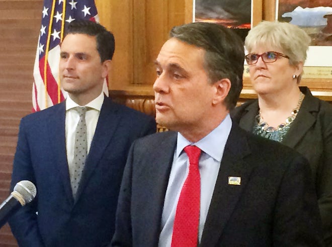 Gov. Jeff Colyer introduces Thursday a new optional online vehicle registration system with John Thomson, chief executive officer of PayIt, and Donna Shelite, interim chief information technology officer in the Colyer administration. [Tim Carpenter/The Capital-Journal]