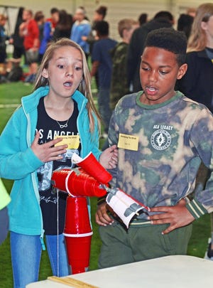 Team members Kynnee Ellebge, 12, and Ketric Carter, 11, from Orr Elementary School watch as their team's windmill works to retrieve a weighted cup during the "Harnessing the Wind" challenge during the Fort Smith STEM Wars competition on Wednesday, March 28, 2018 in the Northside High School activity center. Students in grades 5-6 participated in several STEM (science, technology, engineering, math) competitions during the event. Other members of the team were Parker Laxton and Alex Yancey. [BRIAN D. SANDERFORD/TIMES RECORD]