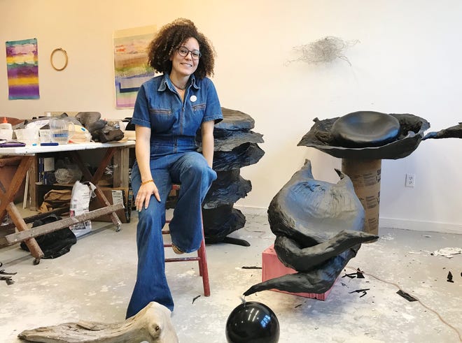 Lydia Hicks communes with the “shark eggs” she created at her Fine Arts Work Center studio. Photo Ann Wood