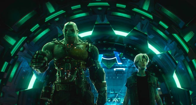 Parzival, right, avatar for Wade Watts, and his sidekick Aech are shown in a scene from "Ready Player One." [Warner Bros. Pictures]